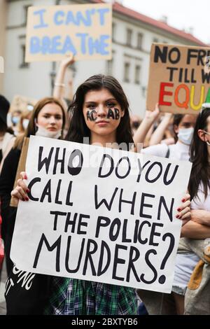 Eine junge Protestierende mit der auf ihr gemalten Abkürzung 'ACAB' hält ein Plakat mit dem Slogan 'When do you Call when the Police Murders?' Während des Black Lives Matter Protests nahmen Hunderte von Jugendlichen an dem Protest "Black Lives Matter" in Krakau, der größten Stadt Südpolens, Teil. Sie zollten George Floyd Tribut und drückten ihre Missbilligung der Polizeibrutalität und des Rassismus aus. Stockfoto