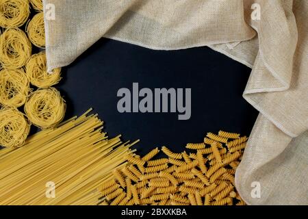 Auswahl von verschiedenen Arten von Pasta trocken auf schwarzem Hintergrund. Stockfoto