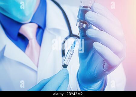 Nahaufnahme auf Spritze und Glas Ampulle in Händen in blauen Gummihandschuhen gekleidet, weiße Robe gekleidet Arzt auf unscharfen Hintergrund Stockfoto