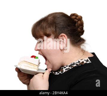übergewichtige Frau Kuchen beißen Stockfoto