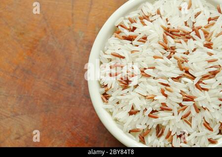 Gemischtes rotes Cargo Paddy auf Schale in weißem Hintergrund Stockfoto