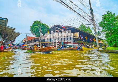 DAMNOEN SADUAK, THAILAND - 13. MAI 2019: Der geschäftige Kanalknotenpunkt in Ton Khem schwimmender Markt, mit Blick auf schäbige Handelspavillons und schnelllebige Stockfoto