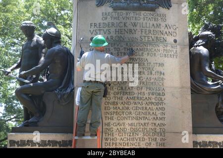 Washington DC, 9. Juni 2020, USA: Ein Mitarbeiter des National Park Service reinigt und malt Briefe, die beschädigt wurden, als Protestierende die Statue sprühen Stockfoto