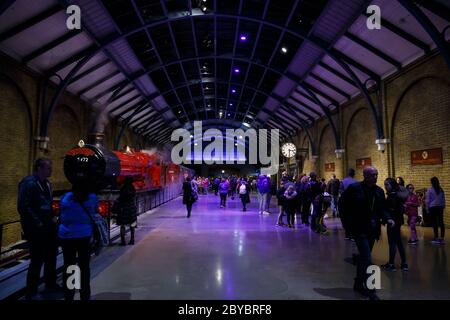 London, Großbritannien - Februar 2020: Besucher auf Plattform 9 3/4 und Hogwarts Express in Warner Brothers Harry Potter Studio Tour. Stockfoto