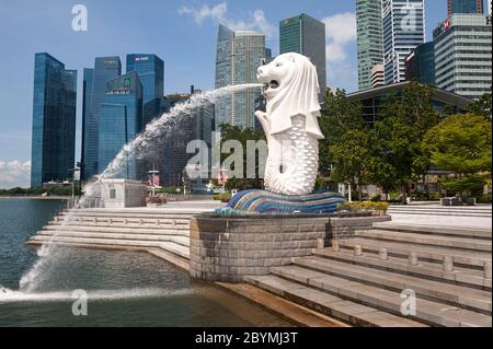 19.05.2020, Singapore, , Singapore - leerer Merlion Park mit Brunnen am Ufer des Singapore River und Wolkenkratzern des Geschäftsviertels in Stockfoto