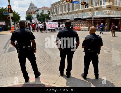 San Antonio Polizeibeamte beobachtet, wie Demonstranten entlang Commerce St. während einer Mahnwache für Charles Roundtree Jr. (erschossen 17. Oktober 2018) und Marquise Jones (erschossen 28. Februar 2014), die von San Antonio Polizeibeamten getötet wurden. Die Veranstaltung wurde von Autonomous Brown Berets de San Anto organisiert und fand im Milam Park statt und marschierte durch die Innenstadt. Stockfoto