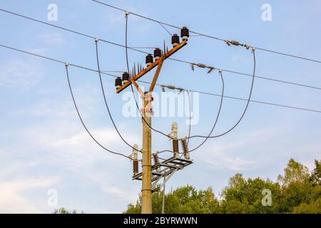 Beton Utility Pole Balken, Isolatoren und offene Drähte gegen Blue Sky Stockfoto