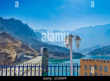 Schöne Berge in der Ferne mit einem Lichtmast im Vordergrund. Vom Quriyat Dam Gelände, Muscat, Oman. Stockfoto