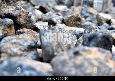 Nahaufnahme von bläulich grauen Felsen, die die Schulter einer Straße pflastern Stockfoto
