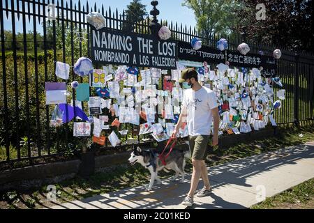 Peking, USA. Mai 2020. Ein Mann mit Gesichtsmaske geht vor dem Green-Wood Cemetery in Brooklyn, New York, am 27. Mai 2020, an einem Denkmal für COVID-19-Opfer vorbei. Kredit: Michael Nagle/Xinhua/Alamy Live News Stockfoto