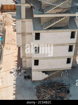Blick in einen hohen Winkel auf ein Gebäude im Bau mit unfertigen Betontreppen und Baustelle Sicherheitsnetz, die schwere Rucke ertragen kann. Stockfoto