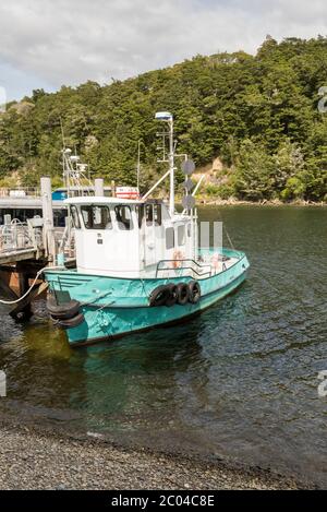 Ein Fischerboot, das an den Docks am Lake Manapouri New Zealand festgemacht ist Stockfoto