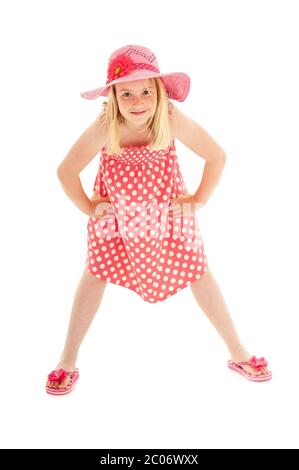 In voller Länge Aufnahme von jungen blonden Mädchen trägt rosa Schlapphut, ein Kleid mit Tupfen und Flip-Flops. Isoliert auf weißem Studiohintergrund Stockfoto
