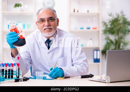 Der alte, im Labor arbeitende Chemiker Stockfoto