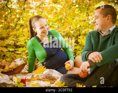 Schwangere paar beim Picknick im Herbst park Stockfoto