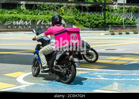 Kurier eines beliebten Lebensmittel-Lieferservice in Malaysia auf einem Fahrrad. Essen bestellen zu Hause. Stockfoto