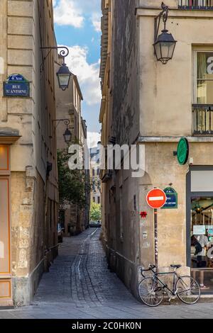 Paris, Frankreich - 25. Mai 2020: Kleine Straße mit alter Straßenlaterne in der Nähe der Rue St Antoine in Paris Stockfoto