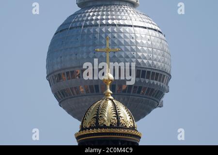 Berlin, Deutschland. Juni 2020. Die Spitze der Kuppel mit Kreuz ist auf dem Neubau des Berliner Schlosses, dem Humboldt Forum, vor dem Fernsehturm am Alexanderplatz (im Hintergrund) zu sehen. Quelle: Jörg Carstensen/dpa/Alamy Live News Stockfoto