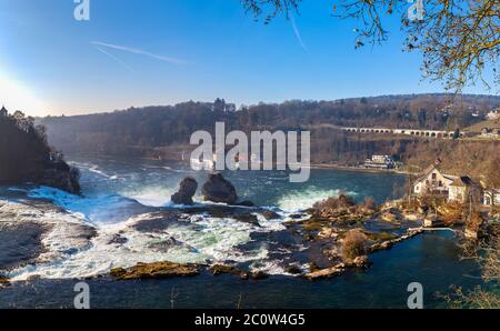 Atemberaubende Luftpanoramasicht auf den Rheinfall, den stärksten Wasserfall Europas am Hochrhein, an sonnigen Herbsttag mit blauem Himmel Klo Stockfoto