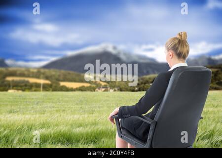 Zusammengesetztes Bild der Geschäftsfrau sitzen auf Drehstuhl im schwarzen Anzug Stockfoto