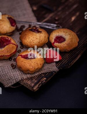 Erdbeer Schokolade Cupcakes Muffins auf alten Holzständer auf Beton grauen Hintergrund. Stockfoto
