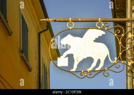 Nahaufnahme eines Flaggenschildes, das den geflügelten Löwen des Hl. Markus, Symbol von Venedig, auf der Außenseite eines alten Gebäudes, Lazise, Verona, Venetien, Italien, darstellt Stockfoto