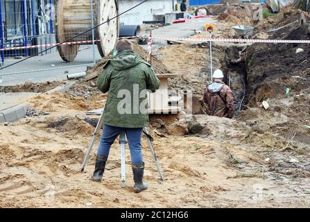 Zwei Vermessungsbauer auf einer Baustelle in der Nähe des Wohnhauses. Stockfoto