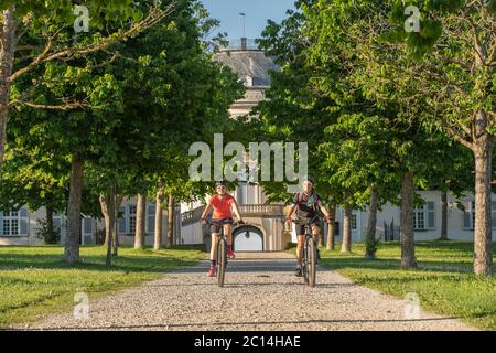 Großmutter und Enkelin reiten mit dem Mountainbike und haben Spaß an einem sonnigen Nachmittag vor dem Schloss Soliude in der Nähe der Stadt Stuttgart Stockfoto