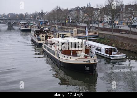 Ausflugsboote befinden sich am Kai der Maas in Maastricht, Niederlande Stockfoto