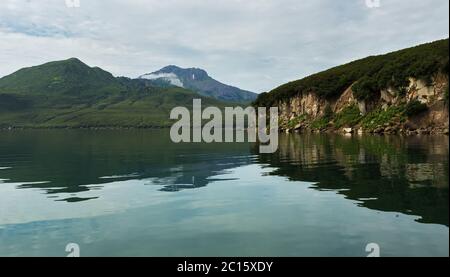 Schöne Küste der Kurilen See spiegelt sich im Wasser. Stockfoto