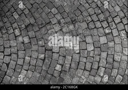 Steinboden Textur. Kopfsteinpflaster aus Granit Pflaster Hintergrund. Zusammenfassung Hintergrund der alten Kopfsteinpflaster close-up Stockfoto