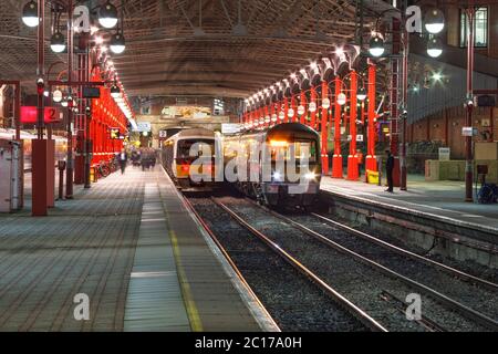 Chiltern Eisenbahn Klasse 165 + Klasse 168 Züge warten auf die Abfahrt von London Marylebone während der abendlichen Rush Hour in einer dunklen Winternacht Stockfoto