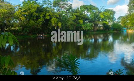 Nueva Loja, Sucumbios / Ecuador - Dezember 21 2019: Paar rudert an einem bewölkten Nachmittag am Stadtrand in der Lagune von Julio Marin mit dem Boot. Stockfoto