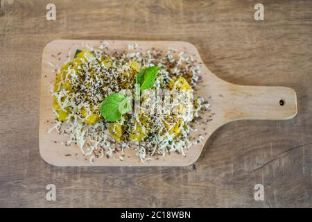 „Pisang Goreng Keju“ ist eine malaysische und indonesische Delikatesse, Bananenfritter mit viel Käse, geriebenen Pralinen und Kondensmilch. Stockfoto