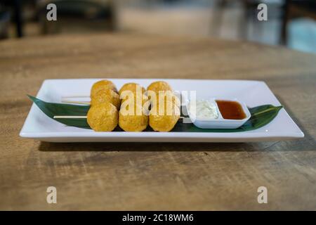 Gebratener Fischball mit Chilisauce und Mayonnaise. Stockfoto