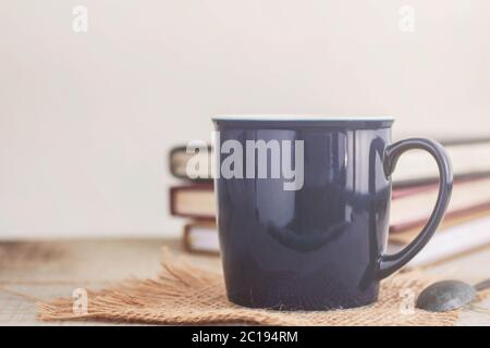 tasse Kaffee und Buch auf Holz. Stockfoto