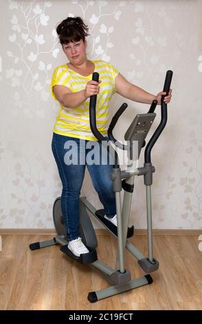 Frau, die auf Trainer Ellipsoid trainiert Stockfoto