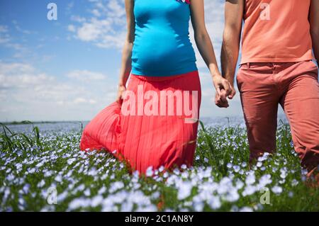 Junge große schwangere Familie in Leinenfeld. Stockfoto