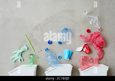 Abbildung von drei Mülltonnen mit sortiertem Müll isoliert auf grauem Hintergrund Stockfoto