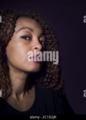 Vertikales Porträt einer afroamerikanischen Frau, die stolz und wütend aussieht Stockfoto