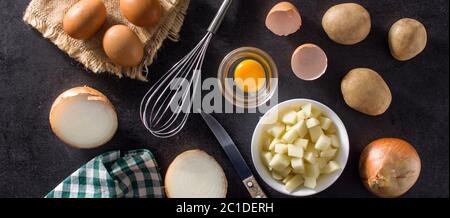 Spanische Omelette Tortilla Zutaten: Eier, Kartoffeln und Zwiebeln auf Holztisch Stockfoto