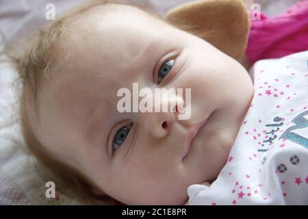 Neugeborenes Baby Portrait mit blauen Augen und einem witzigen Ausdruck auf seinem Gesicht Stockfoto