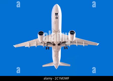 Weißes Flugzeug gegen einen perfekten blauen Himmel Stockfoto