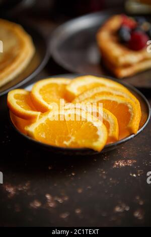 Nahaufnahme auf frischen Orangenscheiben auf Keramik Untertasse gelegt Stockfoto