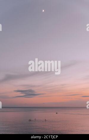 Schöne Farben bei Sonnenuntergang auf ibiza am Meer. Leute, die Paddle surfen mit einem schönen Bild Stockfoto