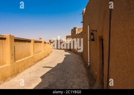 Eine schmale Straße in einem traditionellen arabischen Lehmziegeldorf, Al Majmaah, Saudi-Arabien Stockfoto