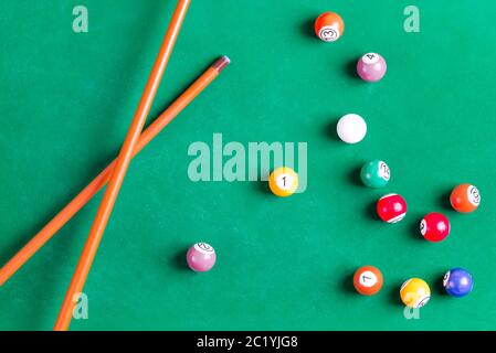 Billard bunte Bälle mit Holzqueue auf grünen Tisch. Snooker, Poolspiel. Draufsicht. Stockfoto