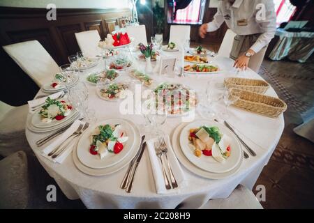 Viele runde Teller mit leckeren Gemüse Schüssel Salat im Restaurant. Stockfoto