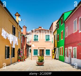 Wäsche hängt an Linien von bunten Häusern in Burano einer Insel in der Lagune von Venedig Italien Stockfoto