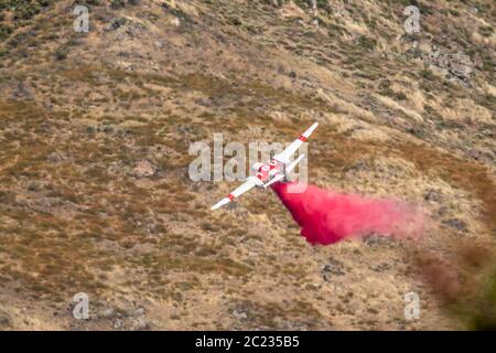 Winchester, CA USA - 14. Juni 2020: CAL Fire Aircraft fällt feuerhemmend auf einem trockenen Waldbrand auf einem Hügel in der Nähe von Winchester, Kalifornien. Stockfoto